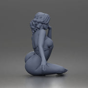 Thoughtful woman sits cross legged wearing strappy harness lingerie set - Only-Games