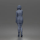 Elegant Woman Standing Gracefully Wearing Strapless Top Skirt And Boots