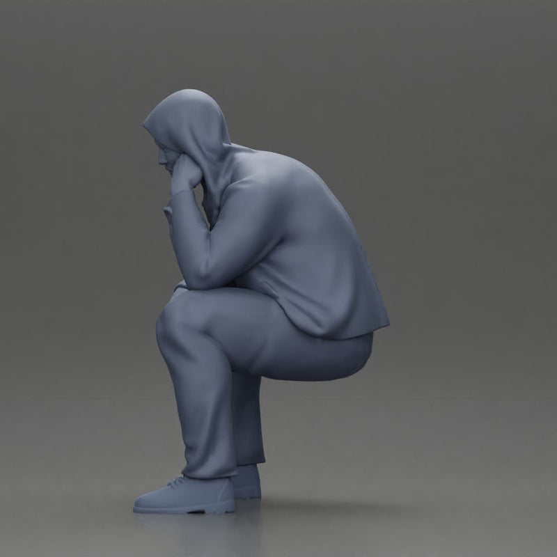 Thoughtful Man in Hoodie Squatting with Hand on His Face - Only-Games