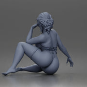 Thoughtful woman sits cross legged wearing strappy harness lingerie set - Only-Games