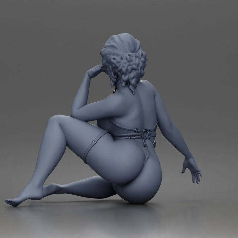 Thoughtful woman sits cross legged wearing strappy harness lingerie set - Only-Games
