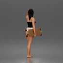 Standing woman holding skateboard wearing halter top and panties
