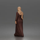 Standing woman looking aside wearing hijab and long belted abaya