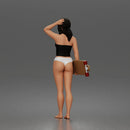 Standing woman holding skateboard wearing halter top and panties