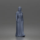Standing woman looking aside wearing hijab and long belted abaya