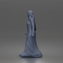 Standing woman looking aside wearing hijab and long belted abaya
