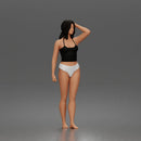 Standing woman holding skateboard wearing halter top and panties