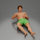 Man in green shorts reclining back raising hands with calm expression - Only-Games