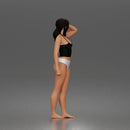 Standing woman holding skateboard wearing halter top and panties