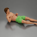 Man in green shorts reclining back raising hands with calm expression - Only-Games
