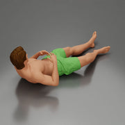 Man in green shorts reclining back raising hands with calm expression - Only-Games