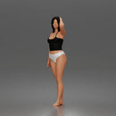 Standing woman holding skateboard wearing halter top and panties