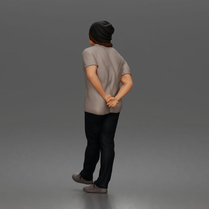 Relaxed young man in beanie standing casually with hands behind back thinking - Only-Games