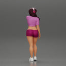 young woman in shorts and headphones shields her eyes from the sunlight - Only-Games