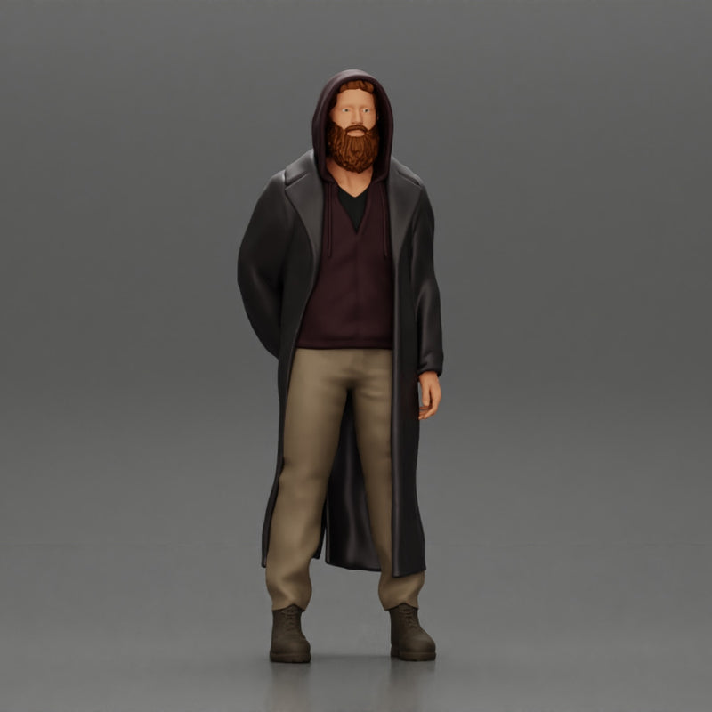 bearded man stands confidently adorned in a stylish hoodie and a flowing long coat