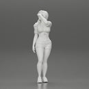 young woman in shorts and headphones shields her eyes from the sunlight - Only-Games