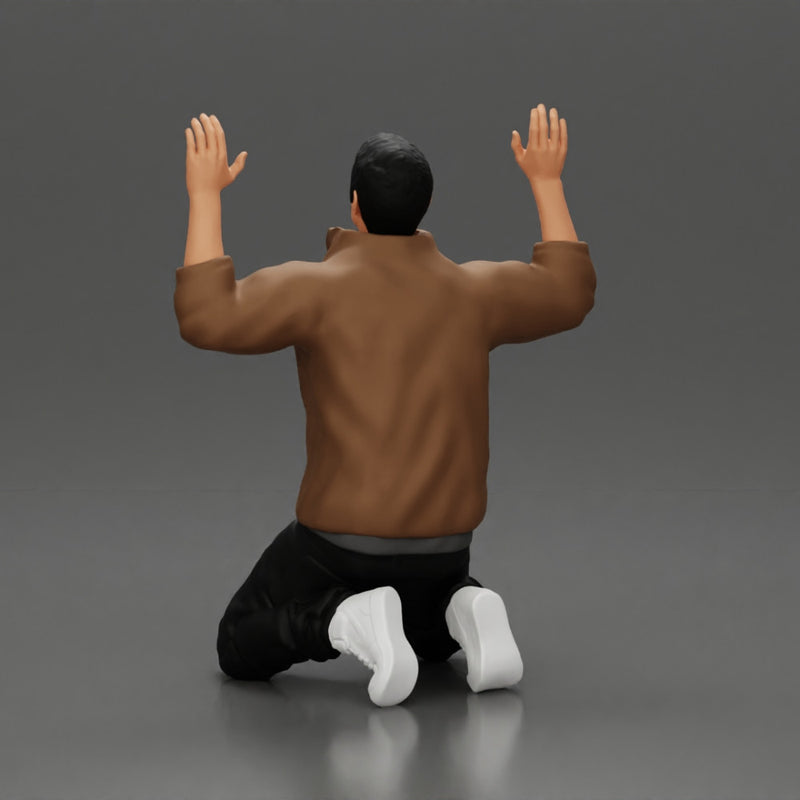 Asian gangster man in jacket sitting with his hands up ready to be arrested