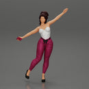 Happy Young Woman in pants Standing on One Leg holding phone - Only-Games