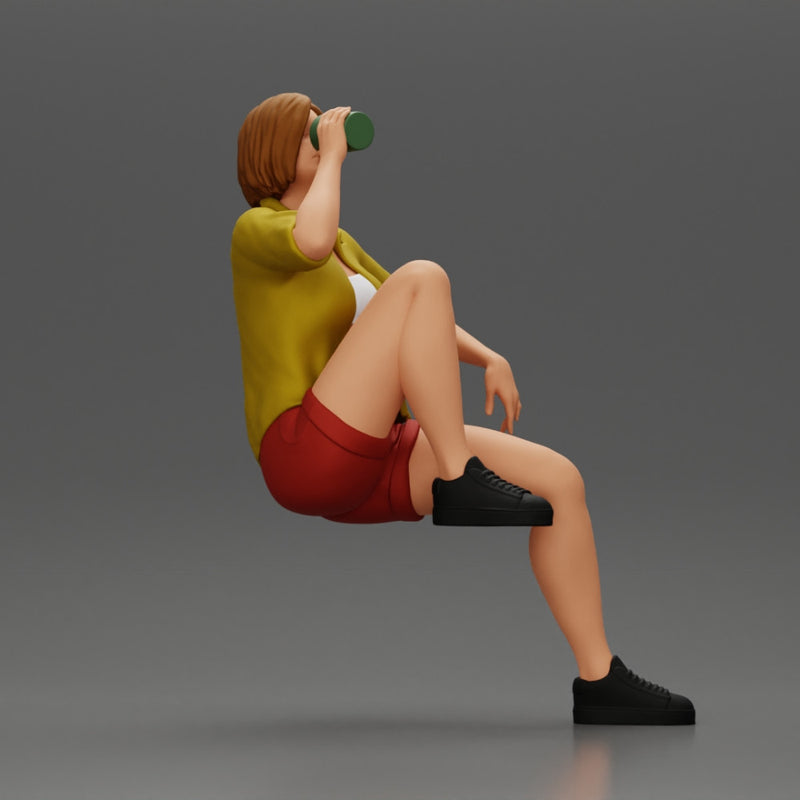 Young woman sitting on a chair hugging her pulled-up leg while drinking