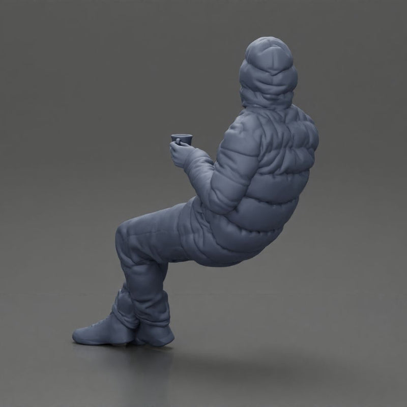 Man Sitting Wearing a Puffer Jacket, Holding a Coffee Cup - Only-Games
