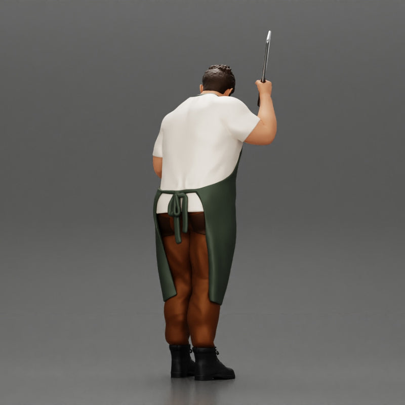 butcher standing while holding a cleaver and cutting something