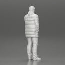 Man in long puffer jacket standing with his hand in his pocket lost in thought - Only-Games