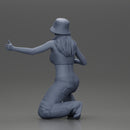 Young girl wearing a hat and pants sitting holding a sign and hitchhiking - Only-Games