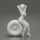 2 Models - SEXY GIRL MECHANIC IN SUIT SITTING ON A TRUCK TYRE AND HANDS IN HAIR - Only-Games