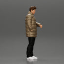 Man in long puffer jacket standing with his hand in his pocket lost in thought - Only-Games
