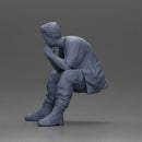 Thoughtful Man Squatting in Casual Outfit, Deep in Contemplation - Only-Games