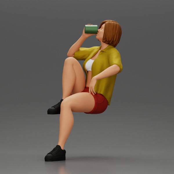 Young woman sitting on a chair hugging her pulled-up leg while drinking