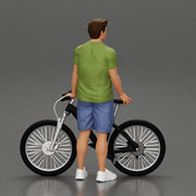 Young Man Standing In The Forest Posing Proudly With His Bike - Only-Games