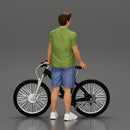 Young Man Standing In The Forest Posing Proudly With His Bike - Only-Games