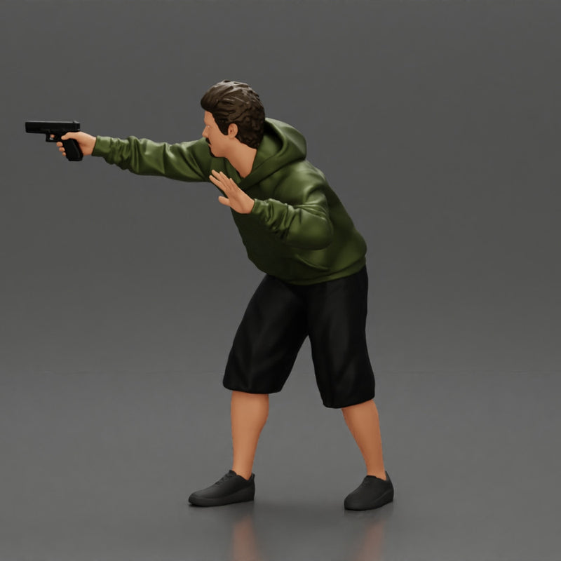 gangster man in a hoodie and shorts shooting a gun behind the car