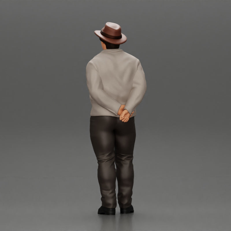 Man in a hat putting hands behind his back ( pablo escobar )