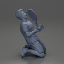 tennis player holding racket sits in celebration of his victory - Only-Games