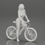 Young sexy sporty woman in pants and snickers short haired posing with bicycle - Only-Games