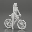 Young sexy sporty woman in pants and snickers short haired posing with bicycle - Only-Games