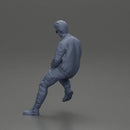 man sitting on a car, wearing a jacket and sunglasses, deep in thought - Only-Games