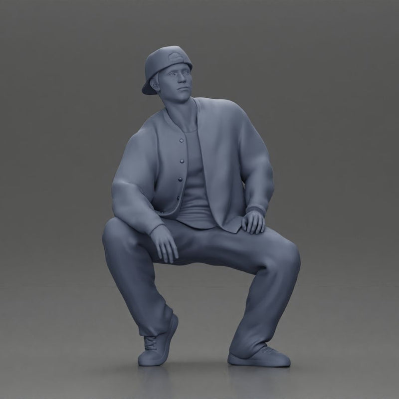 hip hop man sitting in a jacket and cap