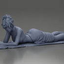 Relaxing on a beach towel, a woman enjoys sunbathing, wrapped in a pareo beach cover and bikini - Only-Games