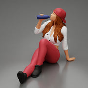 Tired woman mechanic in shirt pants and backwards cap sitting and drinking water during from bottle - Only-Games