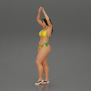 beautiful woman in a bikini with sunglasses standing with her arms raised up on the beach - Only-Games