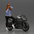 Young woman in  shirt with long hair posing with one foot resting on the motorcycle - Only-Games