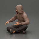 Contemplative man in hoodie sitting cross-legged, expressing curiosity thoughtfully - Only-Games