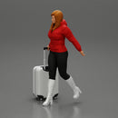 2 Fashion woman in jacket and boots dragging suitcase  walking in airport terminal - Only-Games