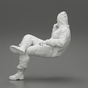 man in leather jacket and jeans sitting cross legged and thinking - Only-Games