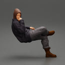 man in leather jacket and jeans sitting cross legged and thinking - Only-Games