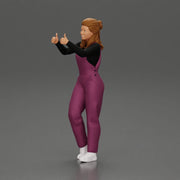 Smiling girl in overalls showing a thumbs up with both hands - Only-Games