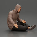 Contemplative man in hoodie sitting cross-legged, expressing curiosity thoughtfully - Only-Games